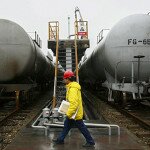 A worker walks past trains transporting oil tanks at a China Petroleum factory in Suining, Sichuan province March 2, 2009. China's energy use in generating each dollar of gross domestic product fell 4.5 percent in 2008, Liu Qi, deputy administrator of the National Energy Administration said. REUTERS/Stringer (CHINA). CHINA OUT. NO COMMERCIAL OR EDITORIAL SALES IN CHINA. - RTXC96G